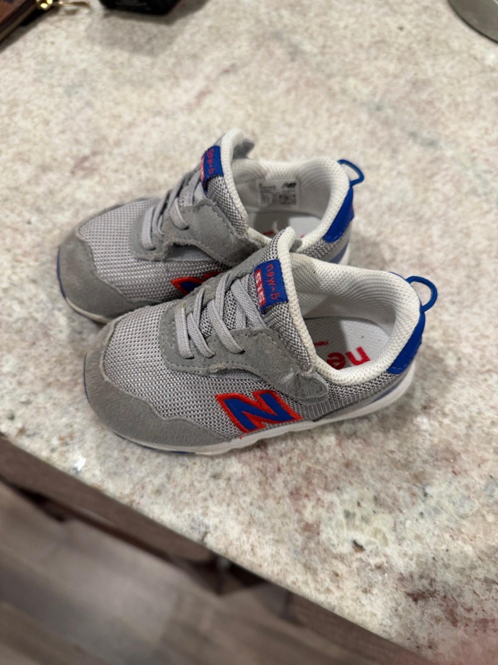 New Balance Kids Gray Sneakers with Blue and Red Accents